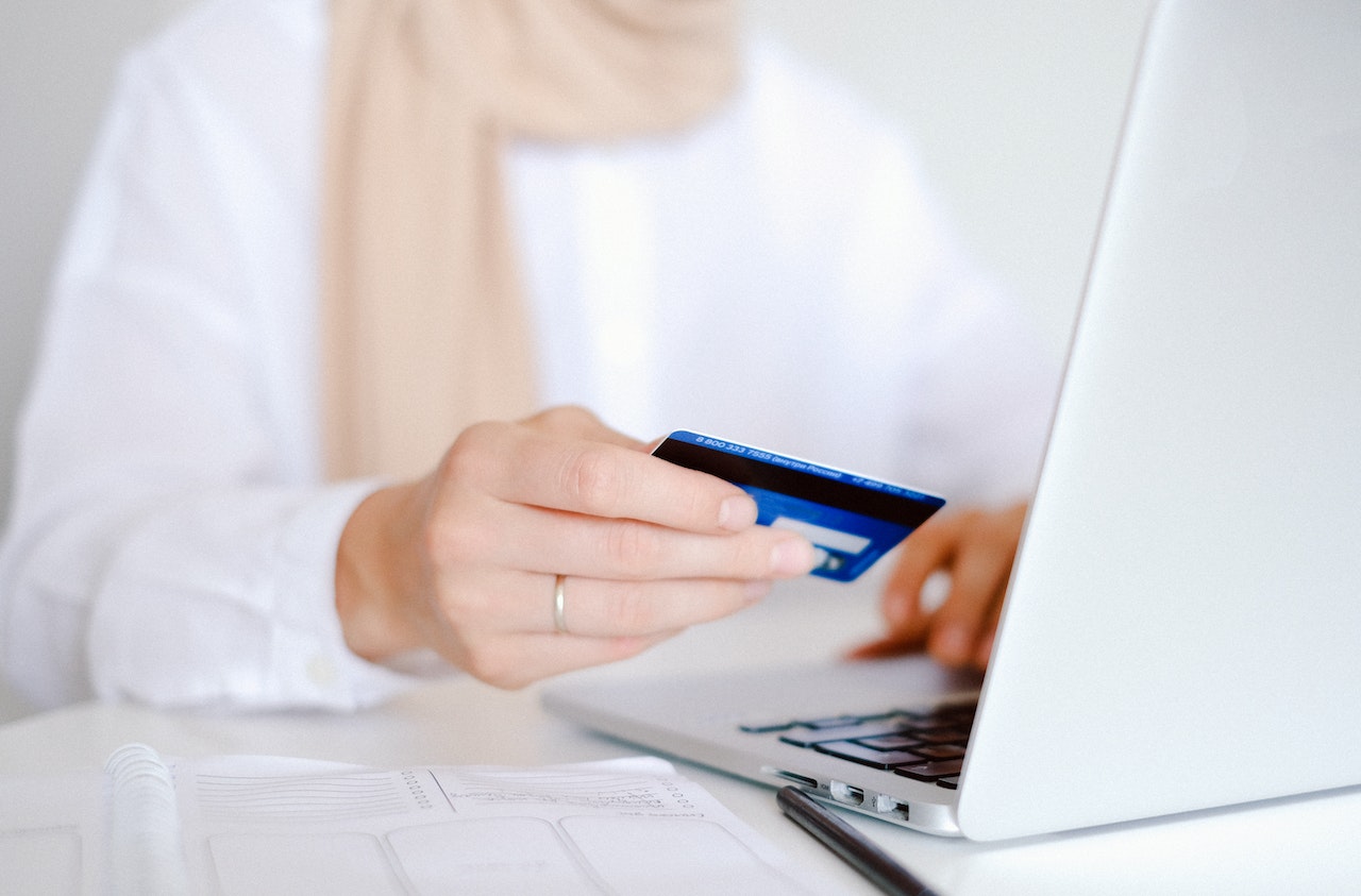 person paying online with card