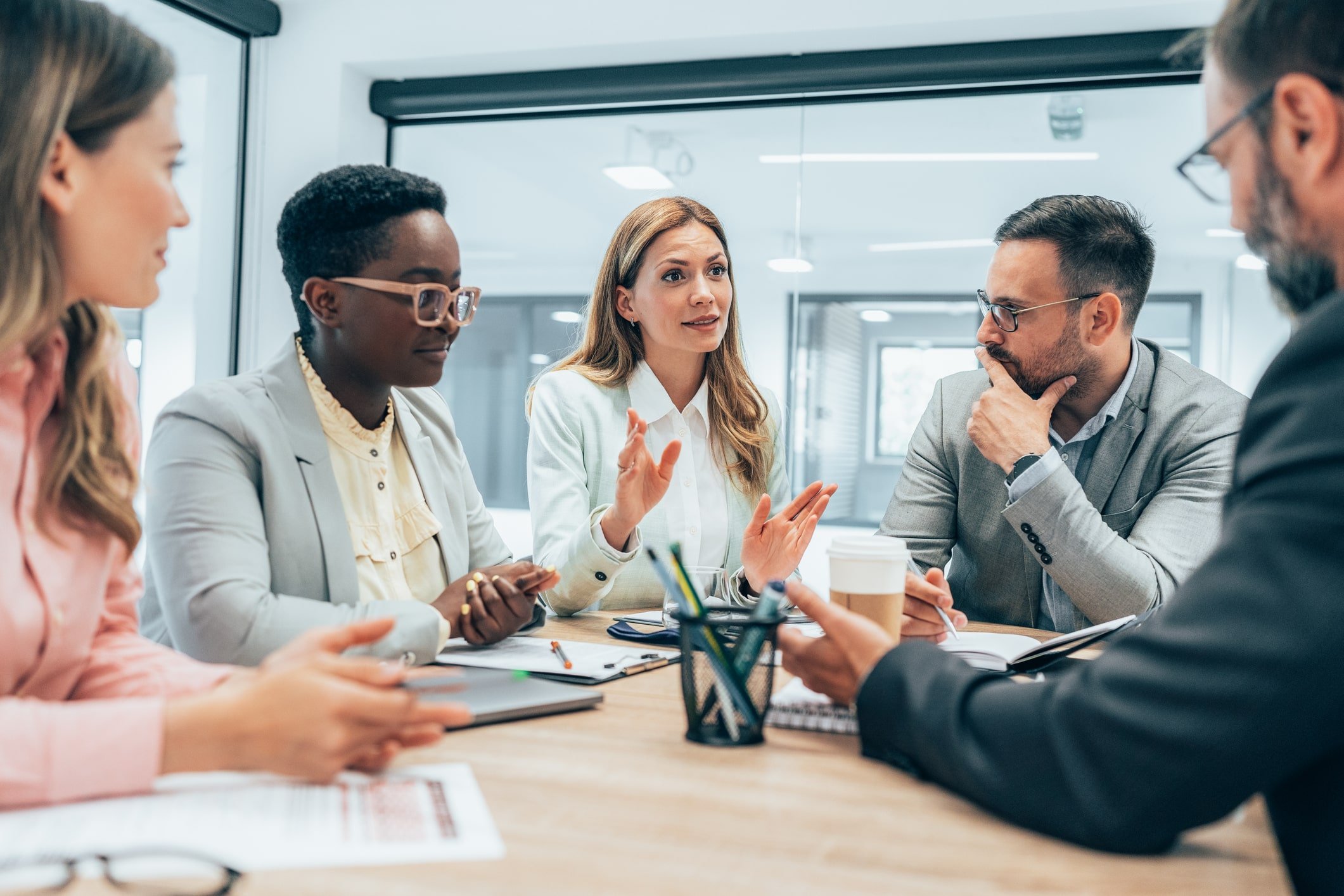 an employee leading discussion in meeting