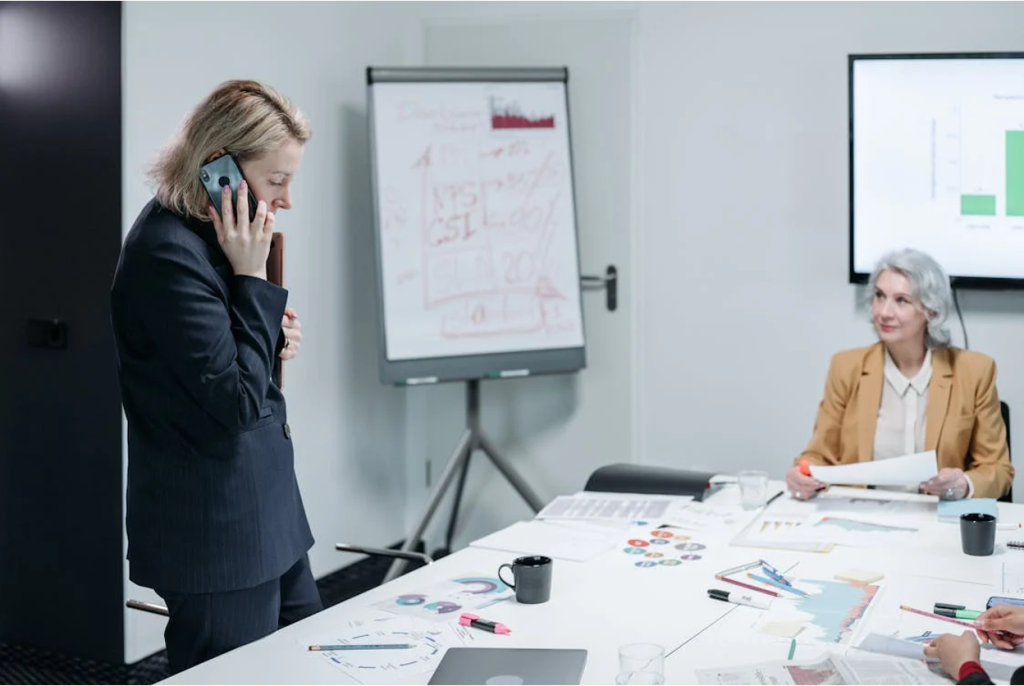 A professional making a phone call during a business meeting