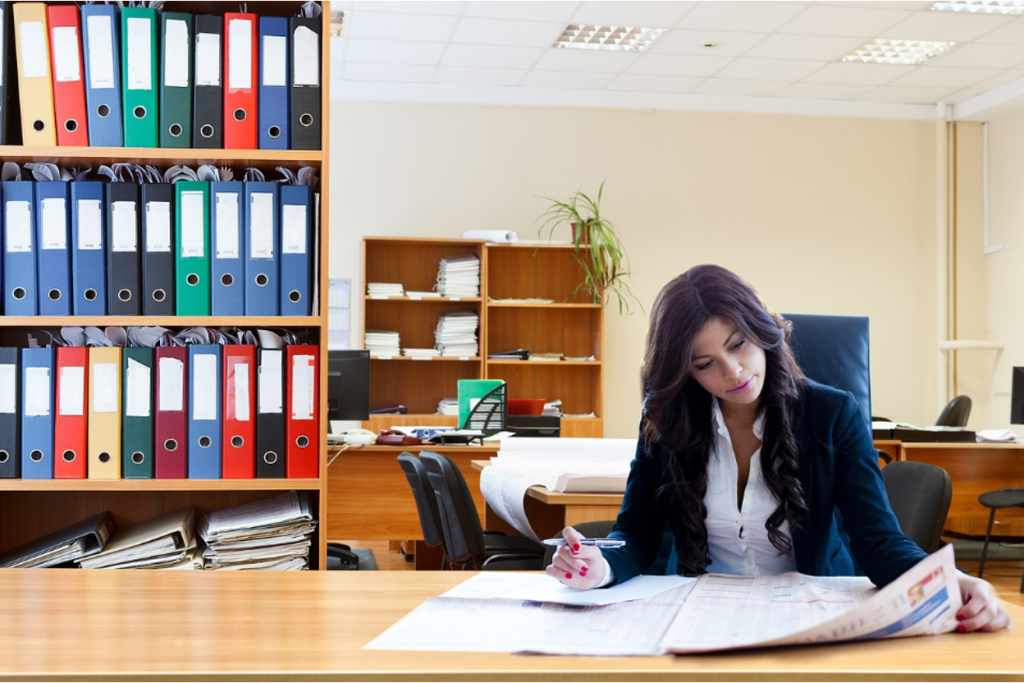 Business owner analyzing financial documents and comparing options on desk