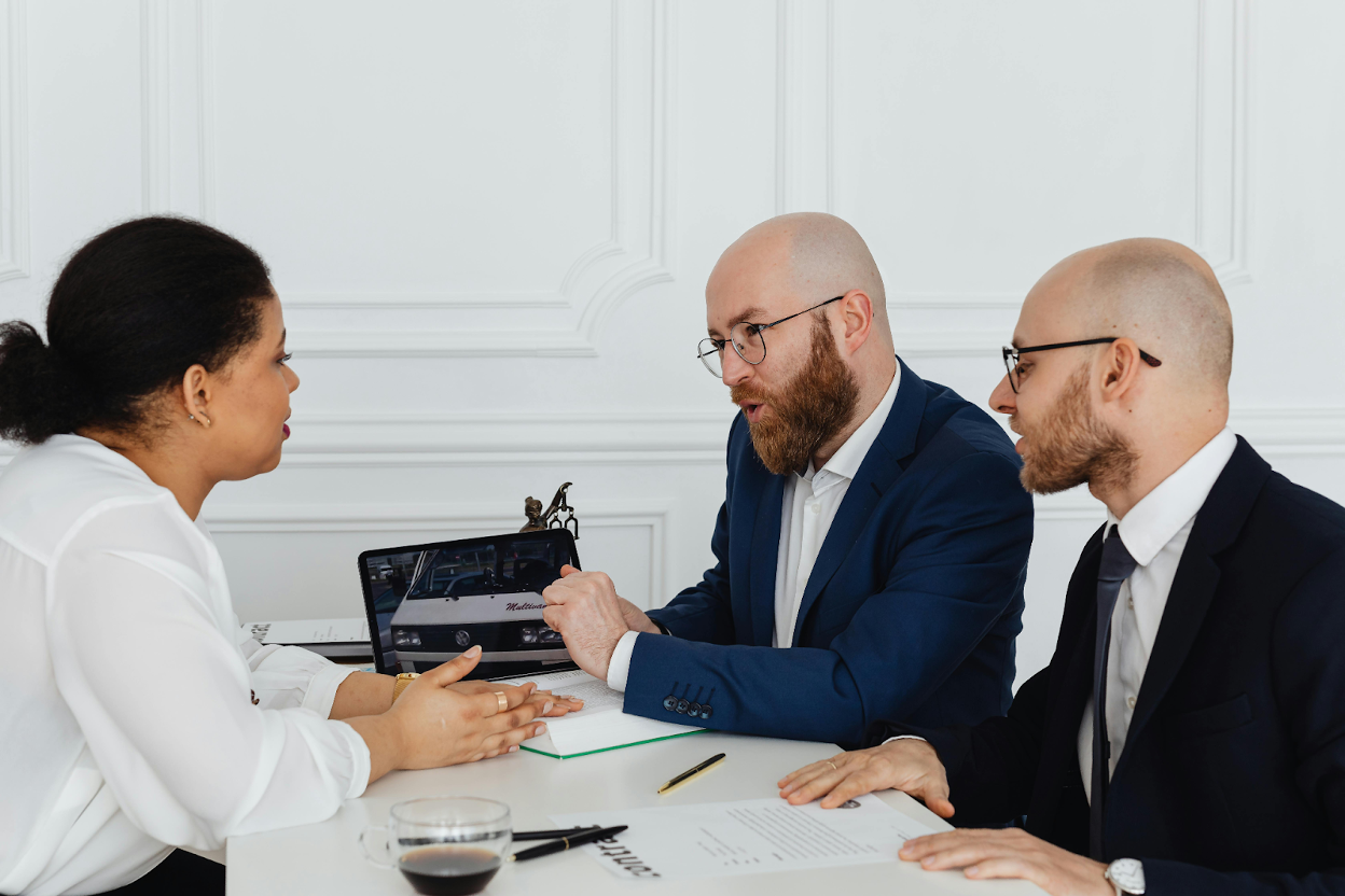 Business professionals discussing during a professional consultation meeting with financial documents.