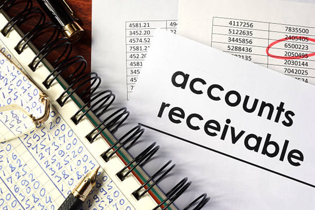 Close-up of accounts receivable documents and financial spreadsheets