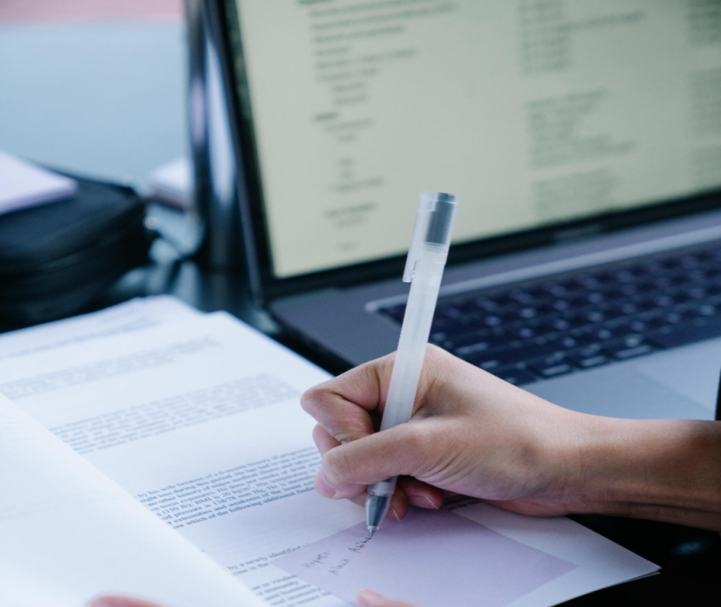 Collection specialist using a computer to verify debtor contact information and business data