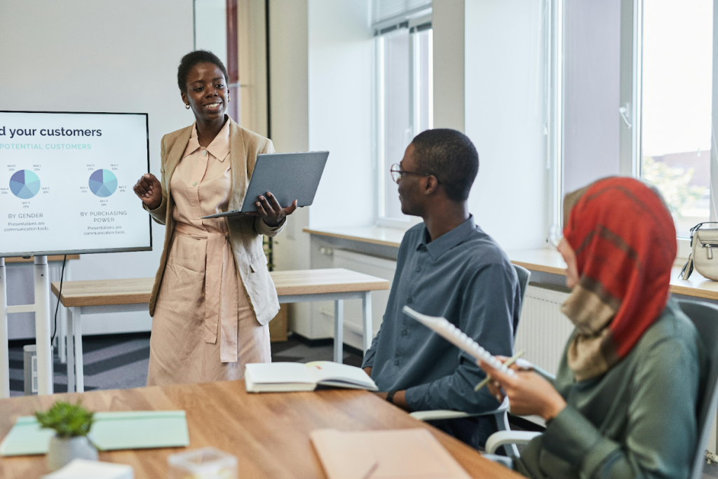 Professional presenting on a screen to colleagues in a meeting room