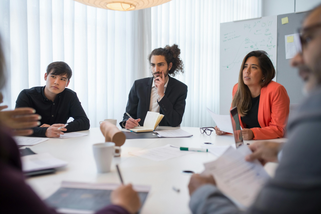 Business professionals engaged in a meeting around a conference table.