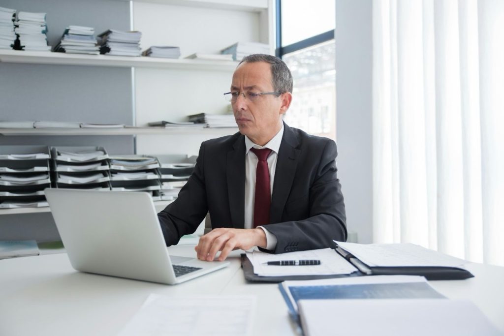 Collection expert reviewing financial documents and accounts receivable