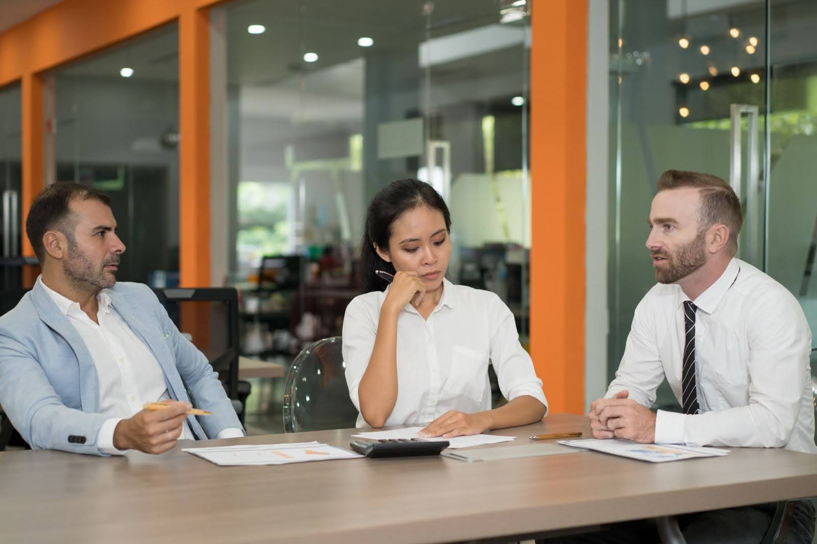 Professional collectors reviewing financial documents in a modern office setting.