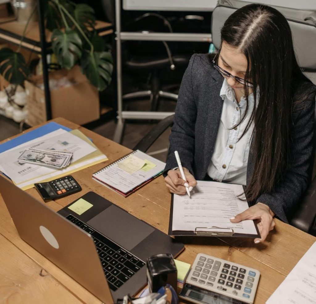 Financial analyst going through cost spreadsheets and recovery calculations.