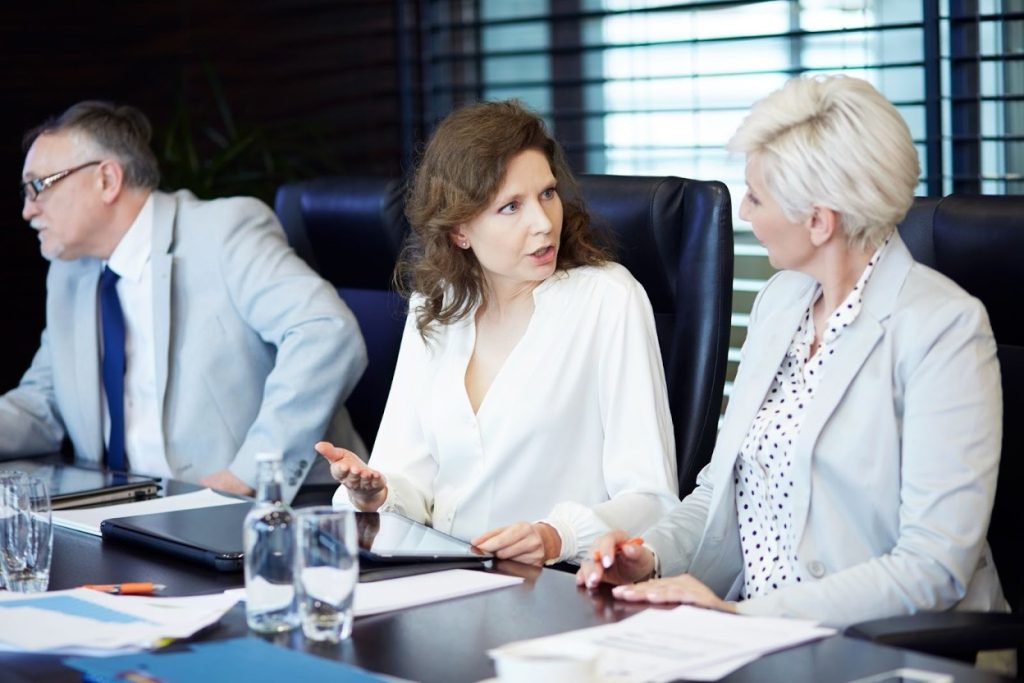 Business professionals reviewing documents and discussing at a table