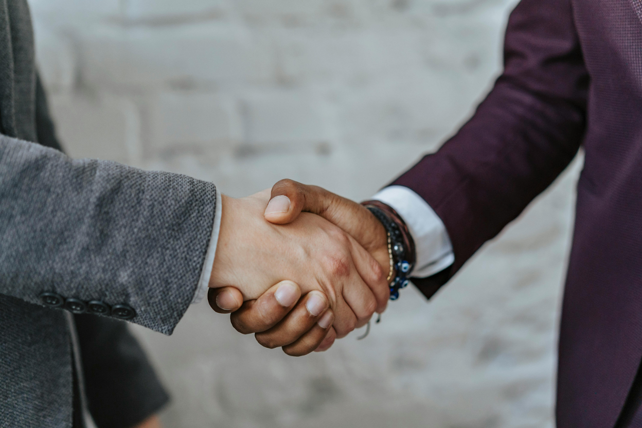 Close-up of two people in business attire shaking hands