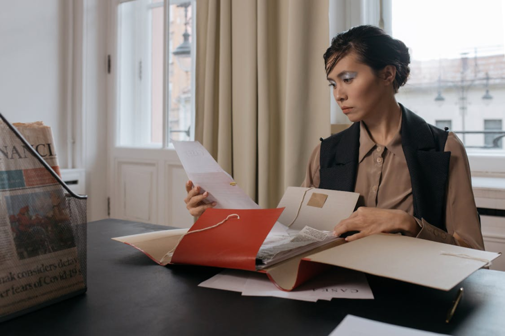 Business owner reviewing debtor contact details and unpaid invoices before starting collections