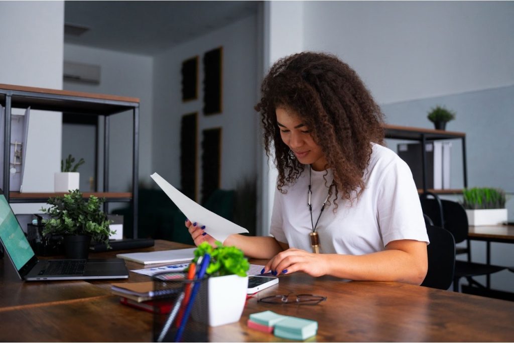 Business professional reviewing a checklist of evaluation criteria at a desk in a modern office