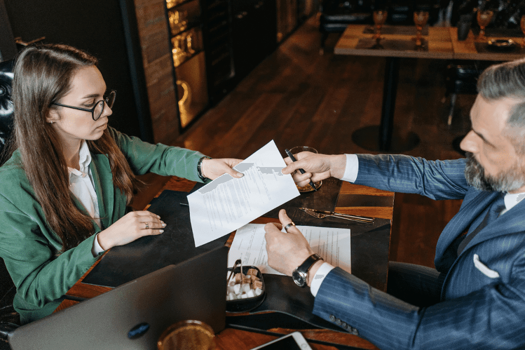 Logistics professionals handing over signed bills of lading to prepare a collections account